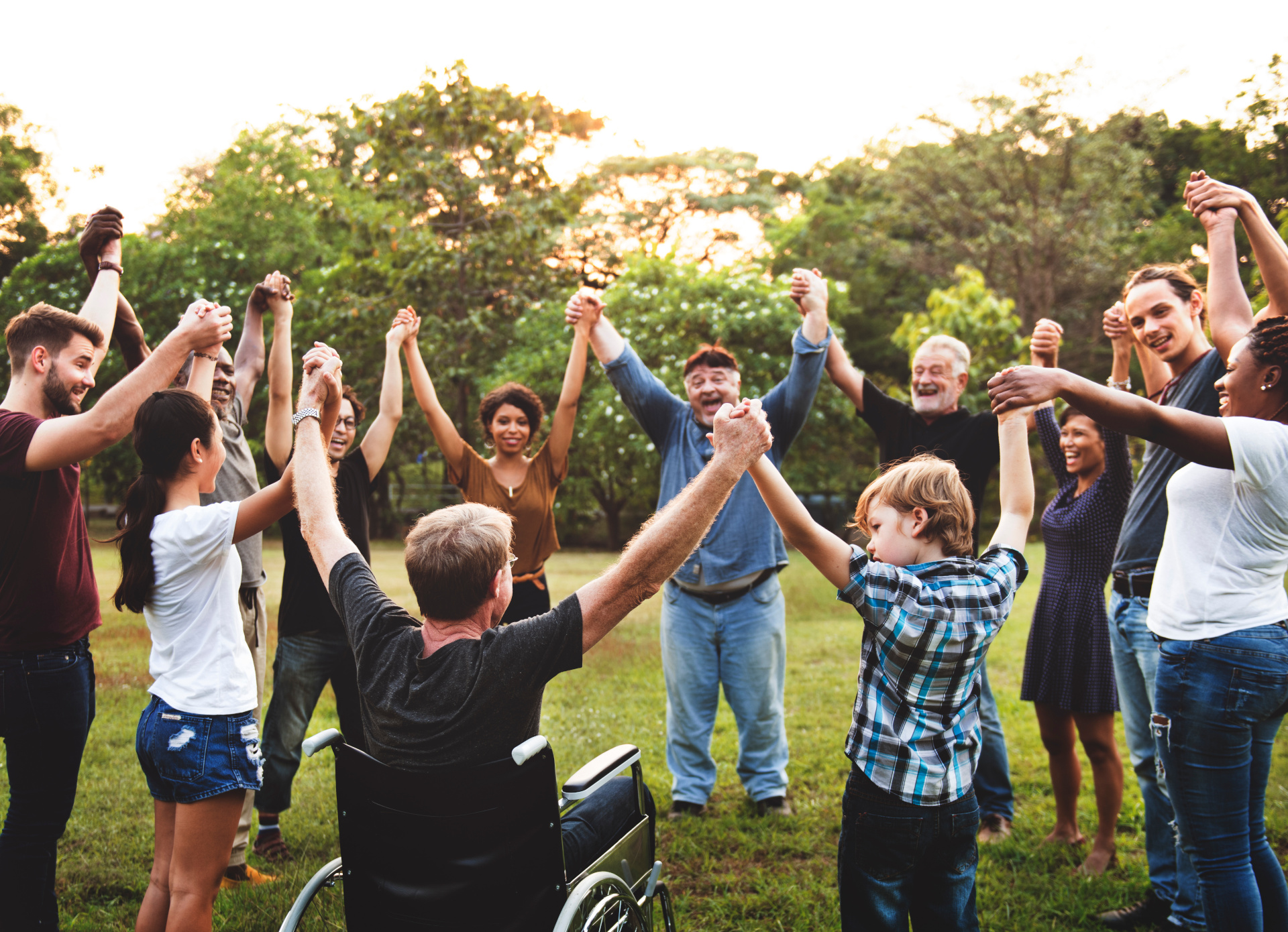 Group of people holding hand together in the park